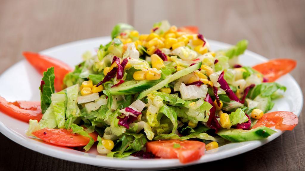 Mediterranean Salad · Romaine lettuce, tomatoes, cucumbers, red cabbage and corn topped mixed with olive and lemon juice dressing.