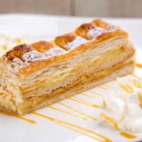 Napoleon · Crisp layers of puff pastry filled with pastry cream and decorated with powdered sugar.