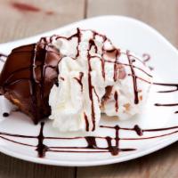 Dark Profiteroles · Cream puffs filled with chocolate and coated in vanilla cream.