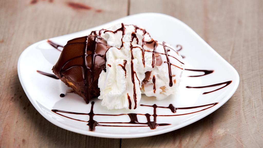 White Profiteroles · Cream puffs filled with vanilla cream and enrobed in chocolate.