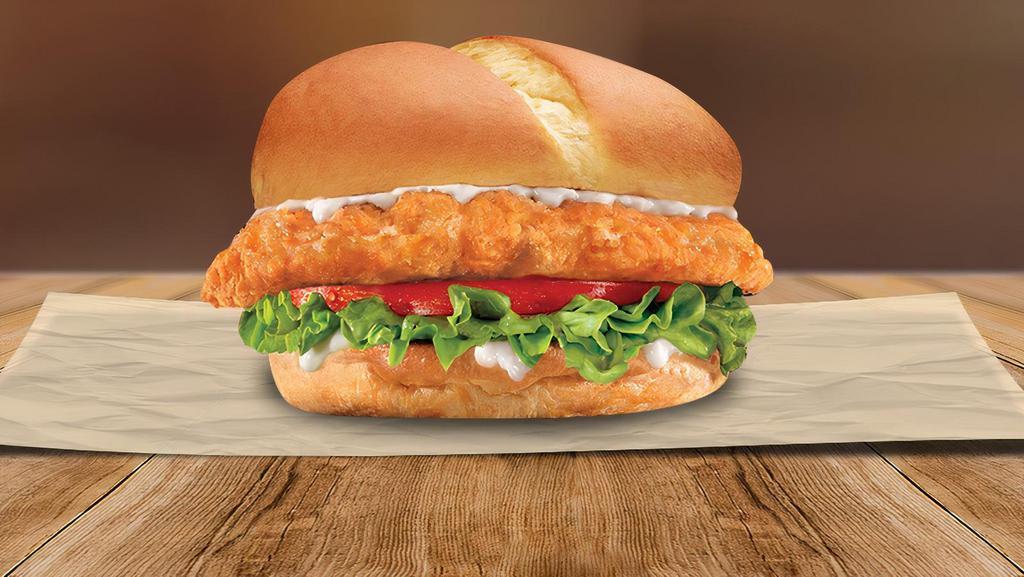 Chicken Sandwich · A 100% natural chicken breast filet with zero additives, marinated to perfection, topped with juicy tomatoes, crisp lettuce, and your choice of sauce on a freshly baked bun. Try it on it’s own, or make it a special with fries and a soda.