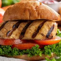 Grilled Chicken Breast Sandwich · Delicious Grilled Chicken Breast sandwich served with cheese, lettuce, tomato, and onions.