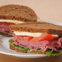 Corned Beef Sandwich · Delicious Corned Beef sandwich served with cheese, lettuce, tomato, and onions.