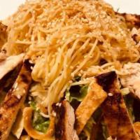 Grilled Chicken Salad · Grilled Chicken Over Mixed Greens, With Angel Hair Pasta, Wontons, Tomatoes, Sesame Seeds, a...
