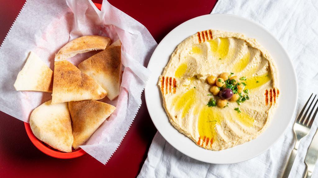 Hummus · Seasoned chick pea and tahini dip. Served with pita bread.