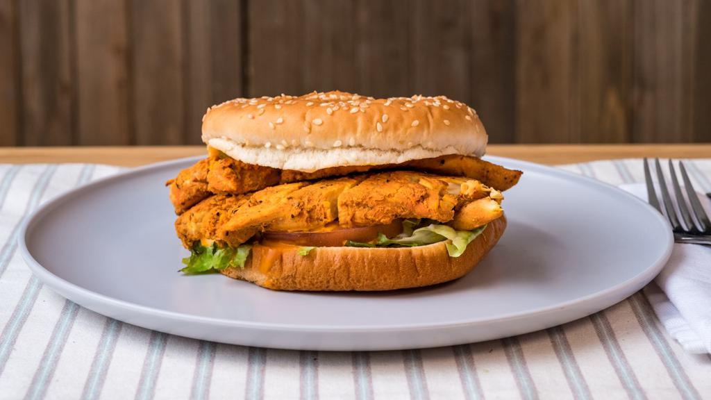 Grill Chicken Sandwich · Halal grill chicken sandwich with lettuce, tomatoes, onions and pickles topped off with a special munchies sauce on a steaming hot brioche bun !