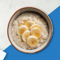 Honey Banana Oatmeal Bowl · Our warm oatmeal bowl is made from rolled oats and oat milk, topped with granola, bananas an...