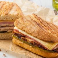 Modern Cuban Sandwich · Fresh roasted pork, ham, melted swiss cheese, delectable pickles, creamy mayo and mustard on...