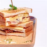 Grilled Three Cheese Triple Decker · Three cheeses of asiago, cheddar, and brie topped with tomato and bacon. Served with your ch...