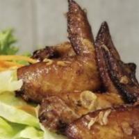 Chicken Wings · Crispy chicken wings served with sweet chili sauce.