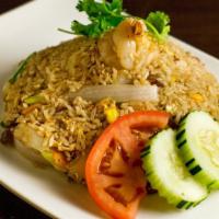 Pineapple Fried Rice · Stir-fried rice with pineapple, cashew nut, tomato, onion, raisin, carrot, scallion, and egg.
