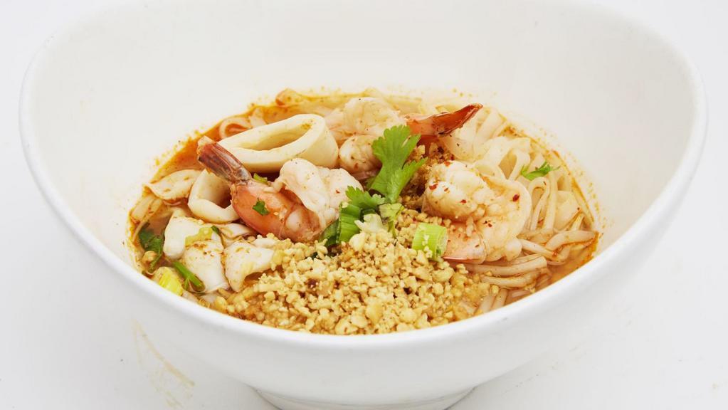 Tom Yum Noodle  · Noodle with shrimp, squid, bean sprout, scallion, cilantro and crushed peanut in tom yum soup.