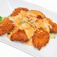Choo Chee Fillet Fish · Crispy tilapia fillet topped with choo chee curry and bell pepper on a bed of mixed vegetable.