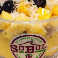 Mango-Pineapple Bowl · We blend mango, pineapple and banana with coconut milk to make a thick fruit smoothie. We th...