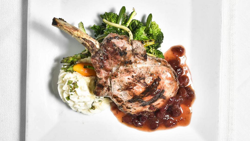 Berkshire Pork Chop · Grilled Berkshire pork chop stuffed with brie cheese and scarole Grand Marnier and cranberry reduction and mint-scented whipped potatoes.