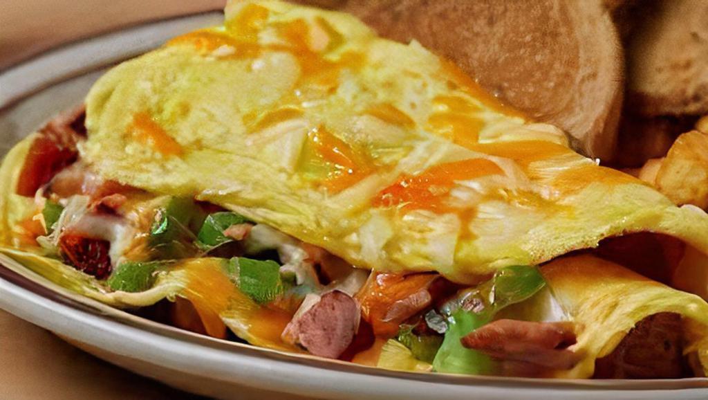 The Western Omelet(3 Eggs) · Fresh Bell Peppers, Onions & Ham Served with white toast