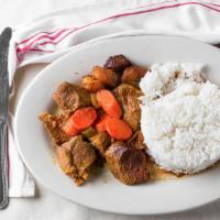 Res Guisada / Beef Stew · Servido con: Arroz y Habichuela o Moro o Yuca o Guineo o Tostones o Maduros / Served w/ Rice...