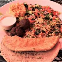 Energy Platter · Hummus, babaganoush, falafel balls, tahini, tomato, feta, cucumber salad.