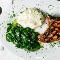 Double Cut Center Pork Chop · With lemon spinach and garlic mashed potatoes.