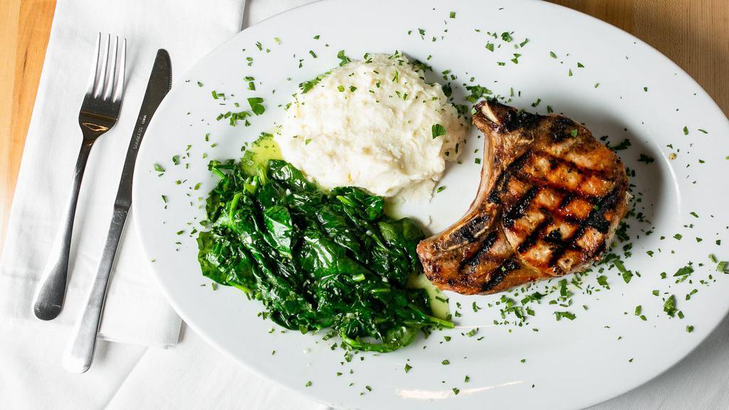 Double Cut Center Pork Chop · With lemon spinach and garlic mashed potatoes.