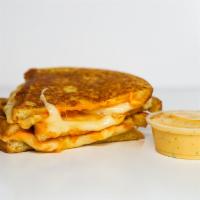 Three Cheese Monte Cristo · Cheddar, Swiss, and Parmesan cheeses melted between egg dipped, griddled sourdough bread. Se...
