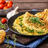 Greek Omelette · Fresh omelette made with scrambled eggs, olive, feta cheese, and tomatoes, served with butte...