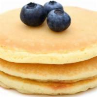 Classic Blueberry Buttermilk Pancakes (3 Pcs) · Classic blueberry pancakes with side of butter and syrup.