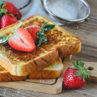 The Strawberry French Toasts · Fluffy French toasts topped strawberries, syrup and butter.