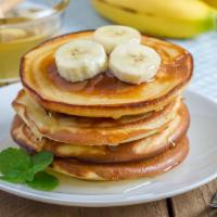 The Banana Pancakes · Fluffy buttermilk pancakes topped bananas, syrup and butter.