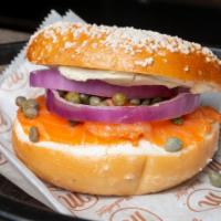 Sliced Nova Lox & Cream Cheese · Sliced smoked salmon, red onions, capers, plain cream cheese on a bagel. Served with pickle ...