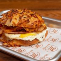 Farmhouse · Cheesy Hash Brown Roll, Grilled Eggs, Bacon, Ham, Cheddar, & country Pepper Cream Cheese