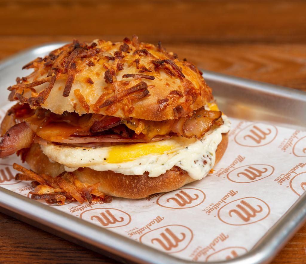 Farmhouse · Cheesy Hash Brown Roll, Grilled Eggs, Bacon, Ham, Cheddar, & country Pepper Cream Cheese