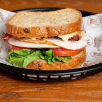 Empire State Turkey Sandwich · Multi-grain bread with turkey, bacon, lettuce, tomato, with mayo. Served with pickle and chi...
