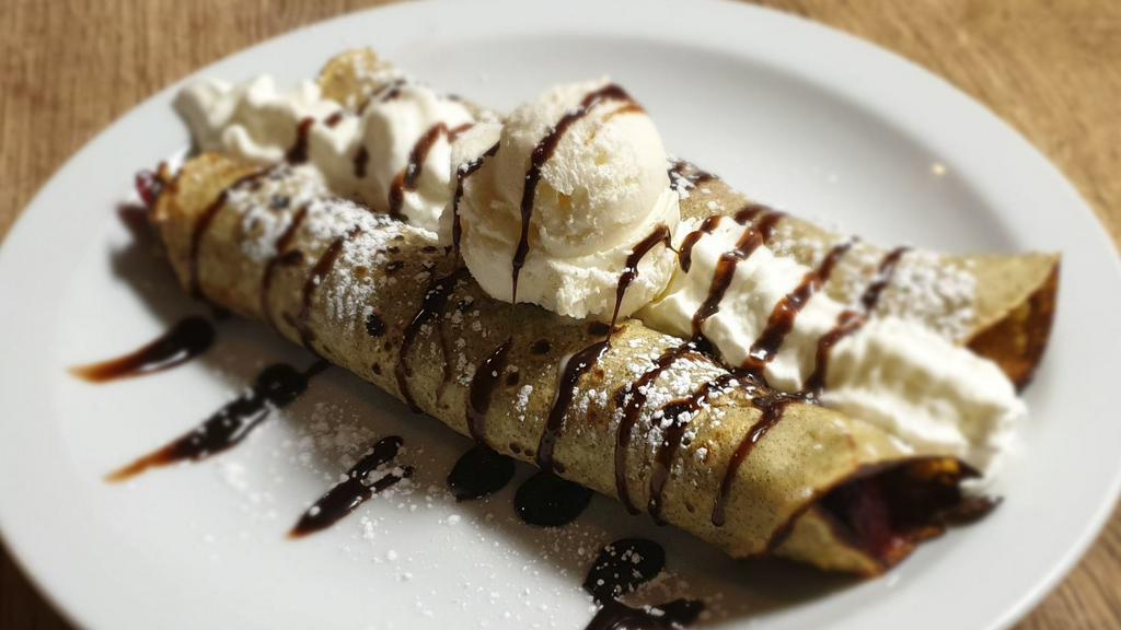 Crepes (2 Pieces) · Served with berries, vanilla ice cream, and chocolate.