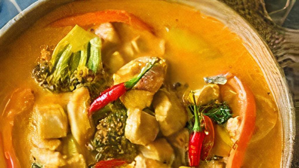 Panang Curry · Spicy panang curry cooked with coconut milk, bell pepper, green bean, pea-carrot and basil topped with kaffir lime leaf.