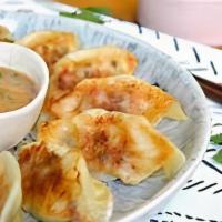 Potstickers · Chicken pot sticker deep fried. Served with red curry sauce.