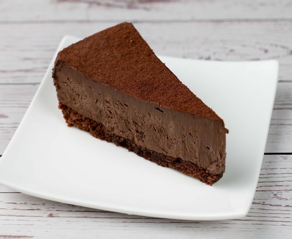 Chocolate Mousse Cake · A chocolate sponge base topped with dark chocolate mousse and dusted with cocoa powder.