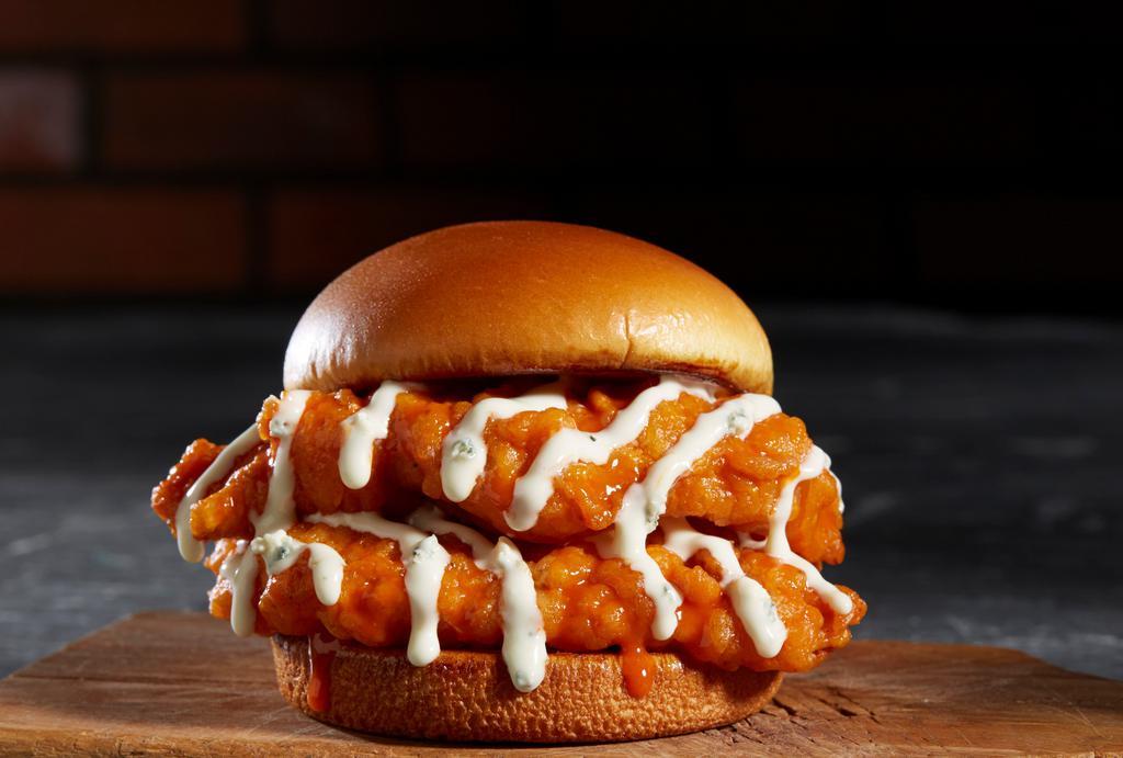 Buffalo Chicken Sandwich · Hand-breaded chicken breast tossed in mild buffalo sauce and topped with melted swiss. Served with blue cheese dressing.
