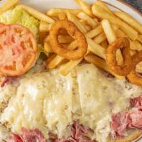 Reuben  Sandwich Deluxe · Served with french fries lettuce tomato onion ring coleslaw and pickle.