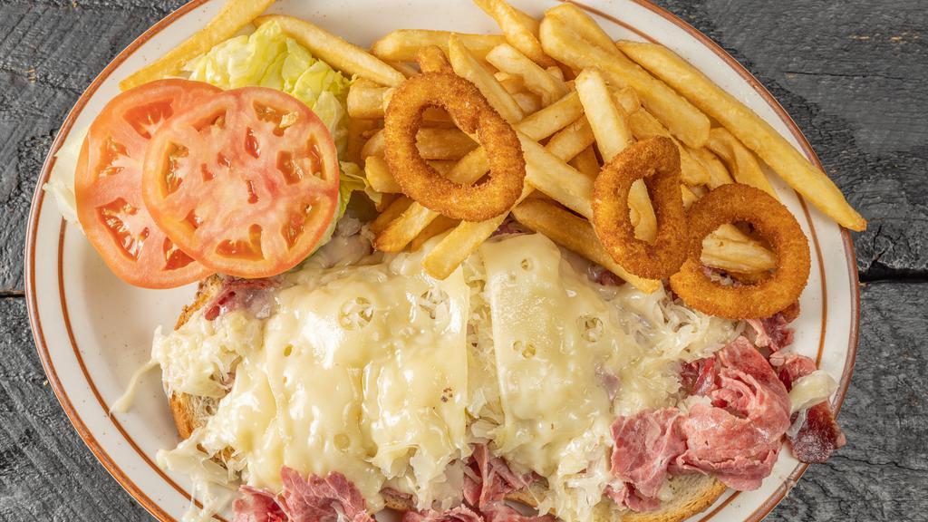 Reuben  Sandwich Deluxe · Served with french fries lettuce tomato onion ring coleslaw and pickle.