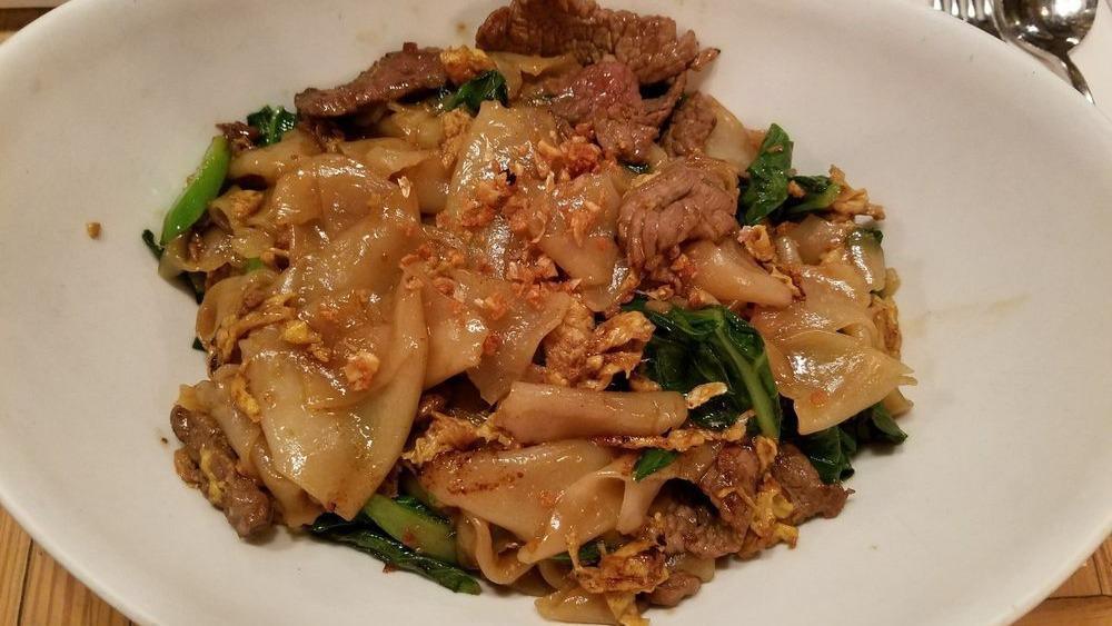 Pad See Ew · Not spicy. Flat rice noodle, Asian broccoli, collard greens, egg, yellow bean soy sauce.

Please inform us of any allergies.
Contains gluten, shellfish and fish sauce.