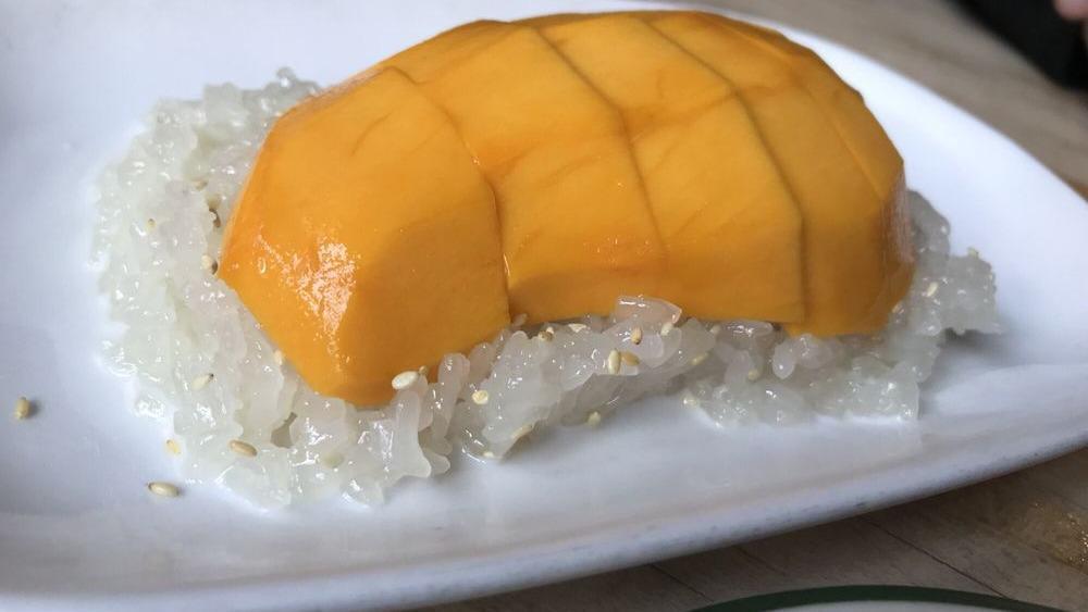 Mango With Coconut Sticky Rice · Champagne mango with coconut sticky rice topped with sesame seeds.

Please inform us of any allergies.
Contains gluten.
