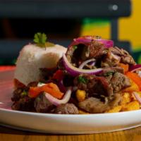 Steak Stir Fry (Lomo Saltado) · Gluten-free. Peruvian stir-fry dish, marinated strips of grass fed sirloin steak, onions, an...