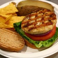 Turkey Burger · Grilled lean turkey burger with lettuce, tomatoes, and onions. Served on a multi grain honey...