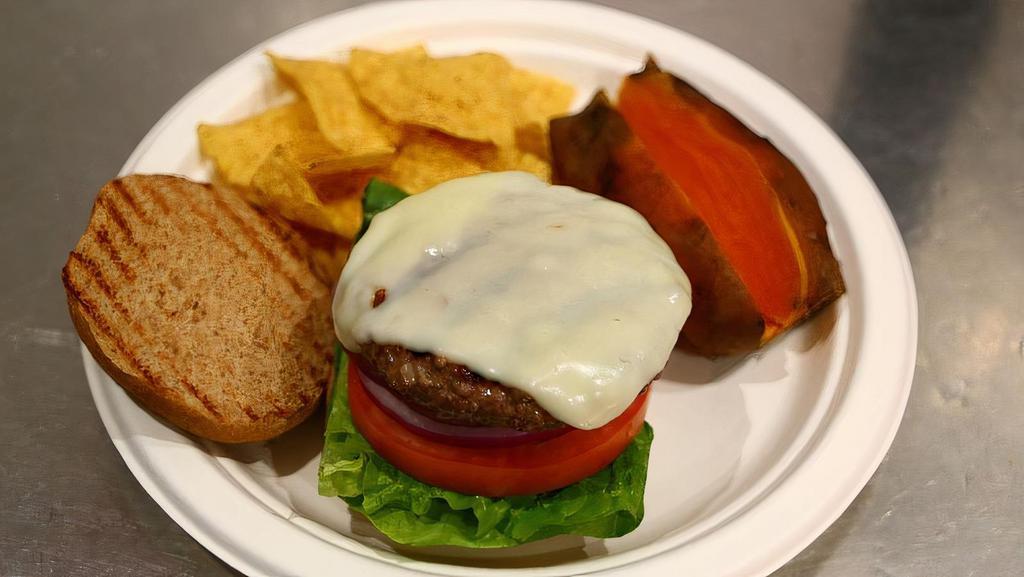 Bison Burger · Premium lean Canadian bison burger with lettuce, tomatoes, onions, and mozzarella. Served on a multi grain honey bun with choice of side.