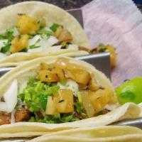Street Taco Pastor · Traditional style pork marinaded in a soft corn tortilla topped with roasted tomatillo salsa...