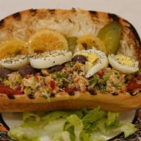 Tunisian Sandwich · Tuna, potato, boiled egg, pickles, olives, pickled lemon, in a baguette, with harissa on the...