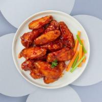 Buffalo Chicken Wings · Five wings cooked and tossed in our buffalo wing sauce. Served with Blue Cheese.