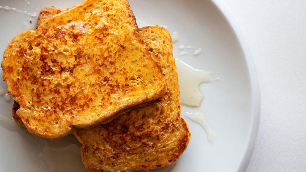 Classic French Toasts · Fluffy french toasts topped with syrup and butter.