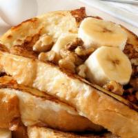 The Banana French Toasts · Fluffy french toasts topped bananas, syrup and butter.
